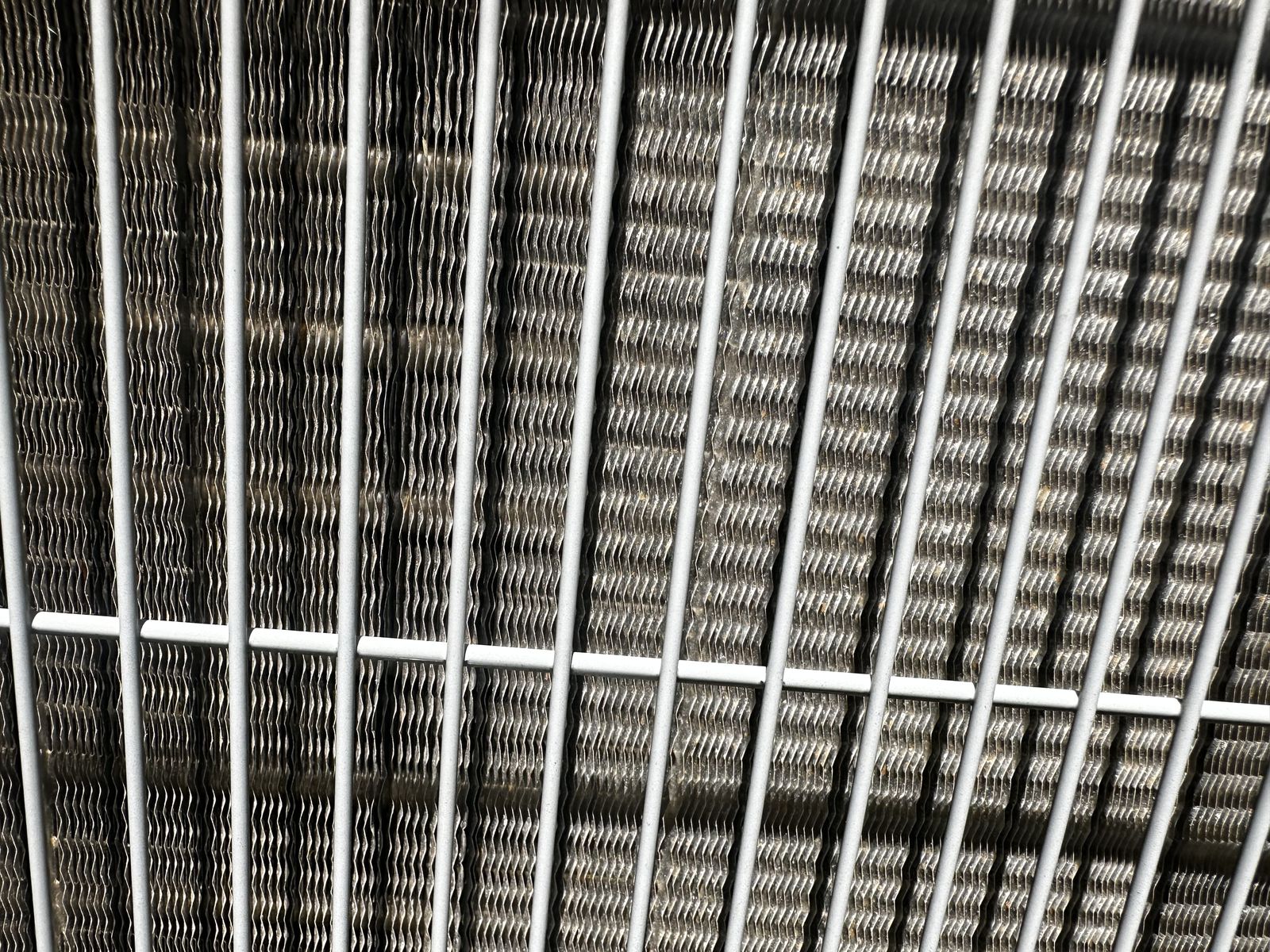 The same AC condenser coil clean and clear after professional service
