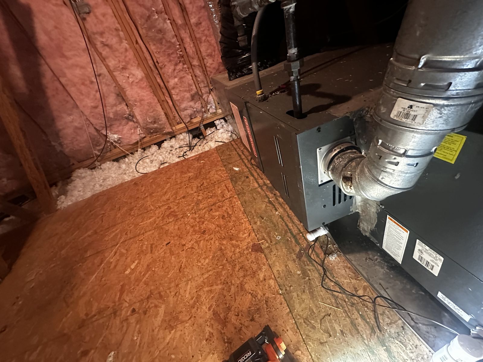 A gas furnace and flue piping inside a home